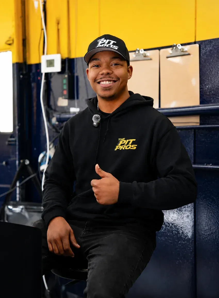 Pit Pros technician giving a thumbs up in the shop